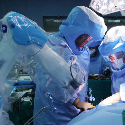 Surgeons performing robotic surgery on a patient