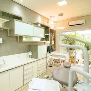 A welcoming dental clinic featuring a comfortable treatment chair surrounded by soft decor, with soothing music