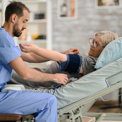 Elderly patient undergoing a routine blood pressure check by a nurse