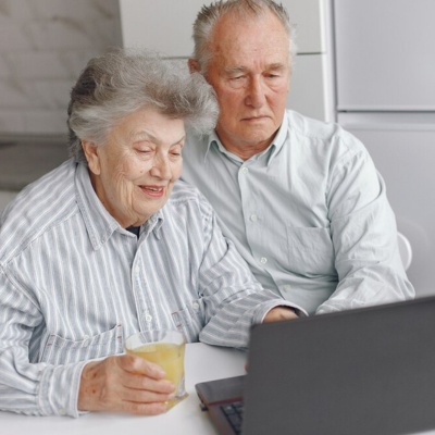 Senior couple exploring hospitals online on a laptop