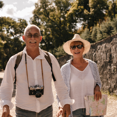 Image of a senior man and woman walking in a tourist site