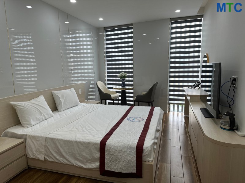 A spacious room with a bed and TV at Australian Dental Clinic, DaNang, Vietnam