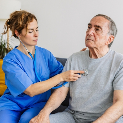 Image of a nurse who is checking an old patient