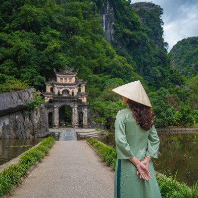 Woman standing in front of a Buddhist Temple in Vietnam