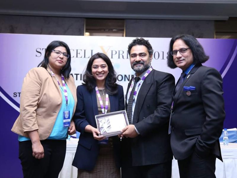 a female dental aesthetics expert receiving an award