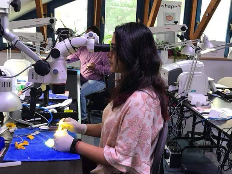 a female indian dentist in a dental lab