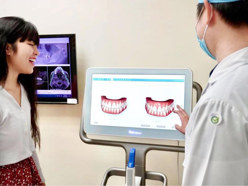 A dentist and a patient looking at a digital scan of teeth