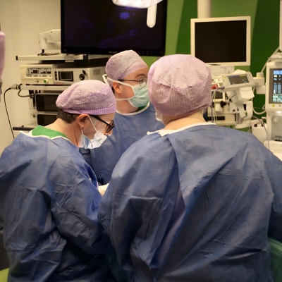 Surgeons in surgery room performing surgery on patients