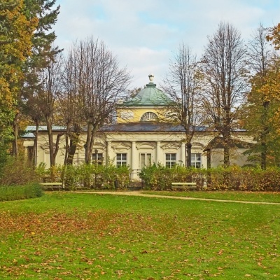 Palace in Cieplice, Poland surrounded by trees and lush green grass