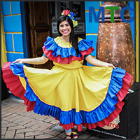 A girl standing in traditional Colombian dress